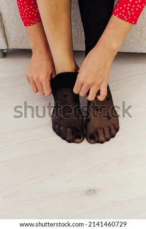 woman wears black tights on legs