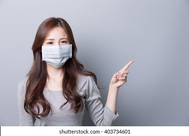 A Woman Wears A Mask And Show Something, Illness, Asian Beauty,gray Background