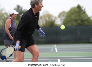 A Woman Wears Rubber Gloves While Playing Pickleball