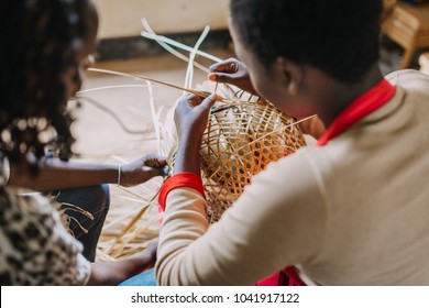 Woman Weaving A Basket Out Of Bamboo In Rwanda Africa