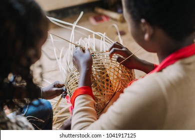 Woman Weaving A Basket Out Of Bamboo In Rwanda Africa