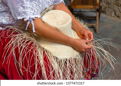 A woman weaving a Panama hat, also known as the traditional brimmed straw hat made of the Toquilla palm, which is on the Unesco Intangible Cultural list and famous from the city of Cuenca, Ecuador. - Powered by Shutterstock