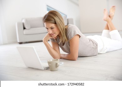 Woman websurfing on the net with laptop
