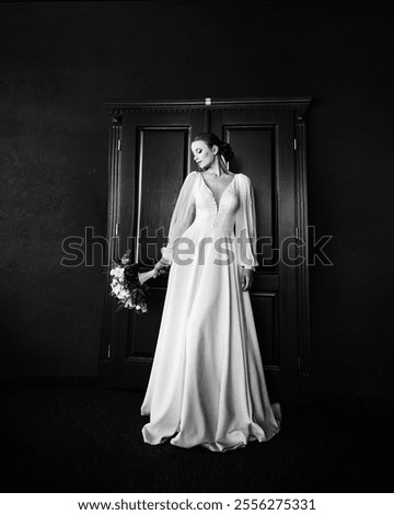 Similar – Image, Stock Photo bride in a long white dress with a wedding bouquet along with a groom in a stylish suit after a wedding ceremony in front wall with green ivy