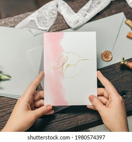 Woman with a wedding invitation card mockup - Shutterstock ID 1980574397