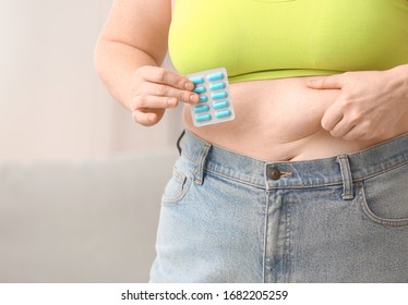 Woman With Weight Loss Pills At Home, Closeup