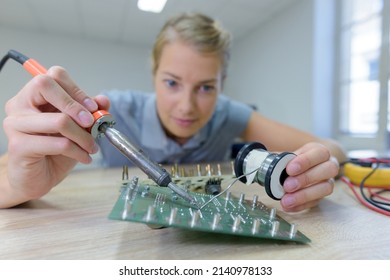 A Woman Welding A Drone