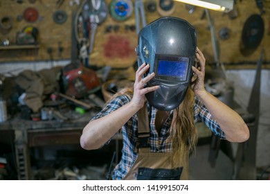 Woman With Welding Mask In Workshop