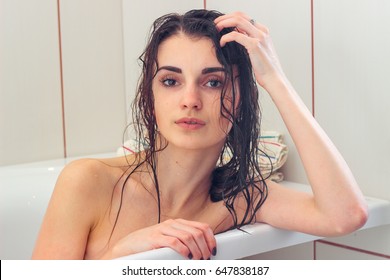 Woman With Wet Hair Lies In The Bathroom