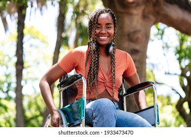 Woman in wheelchair listening music with headphones. - Powered by Shutterstock