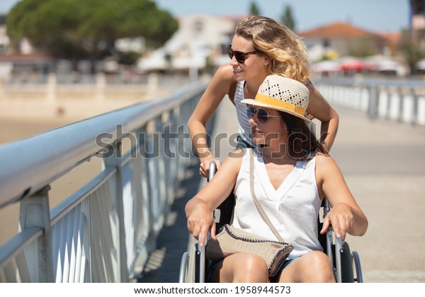 woman in a wheelchair on a\
pier