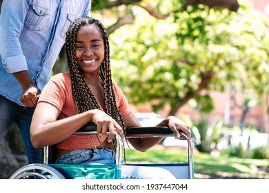 Woman in a wheelchair at the park with her boyfriend. - Powered by Shutterstock