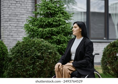 A woman in a wheelchair sits thoughtfully in a garden. - Powered by Shutterstock