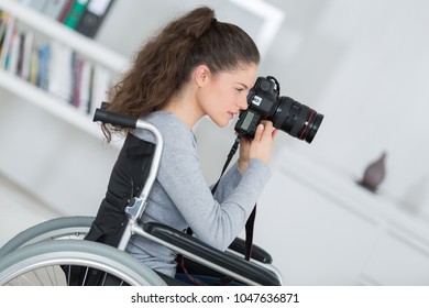 woman in wheelchair training to become photographer - Powered by Shutterstock