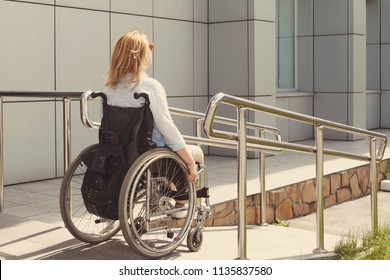 Woman In A Wheelchair Using A Ramp