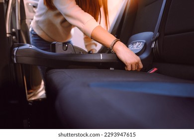 Woman while placing swivel base of car seat