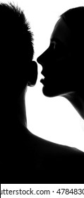 Woman Whispering At Ear In Studio Silhouette