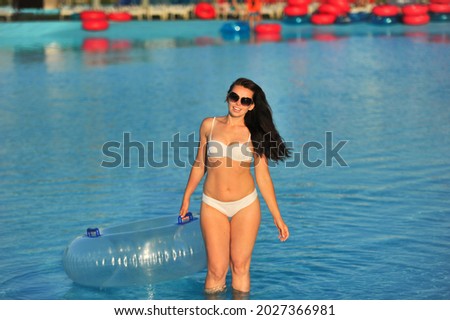 Similar – Brunette surfer woman with top and bikini holding surfboard