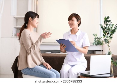 A woman in a white coat and a woman receiving counseling
 - Powered by Shutterstock