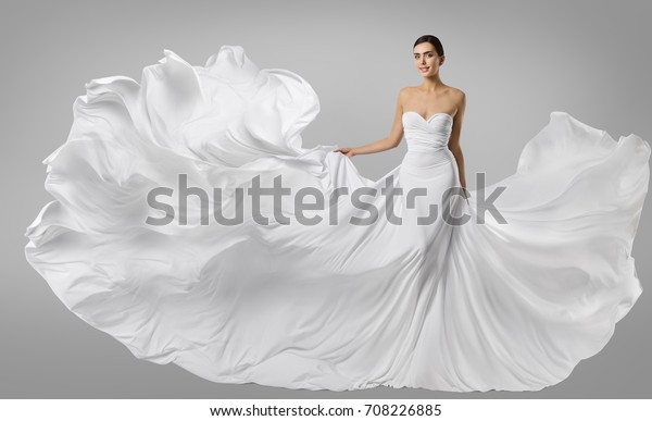 女性の白いドレス 長い絹のガウンのファッションモデル なびく飛ぶ織物 風にひらめく の写真素材 今すぐ編集