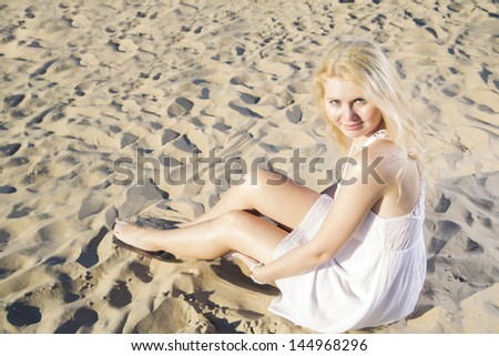 Similar – Young, slender, long-legged woman on a Baltic beach in a summer dress