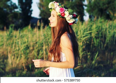 Woman In White Dress Standing In Field Wearing Flower Crown. Young Forest Inspired Bride, Bohemian Girl, Photo Toned Style Instagram Filters.