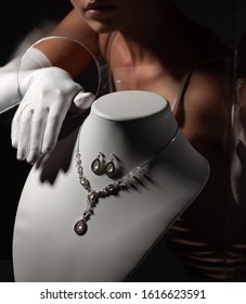 A Woman In White Gloves Stealing Jewelry