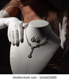 A Woman In White Gloves Stealing Jewelry