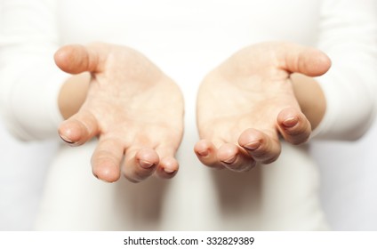 The woman in white holding open hands - Shutterstock ID 332829389