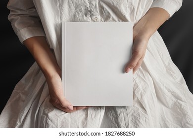 Woman In White Presenting A Book Mockup.