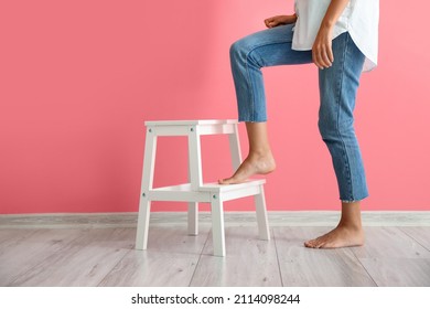 Woman With White Step Stool Near Pink Wall