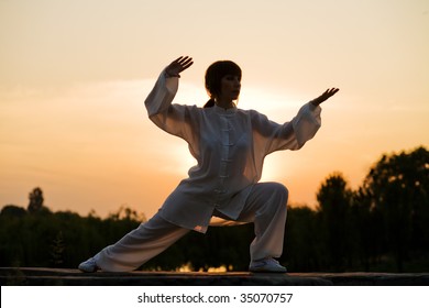 Woman In White Suit Make's Taiji Chuan Exercise - Chinese Marshal Art