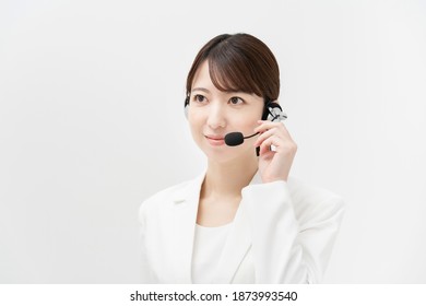 Woman In White Suit Wearing A Headset