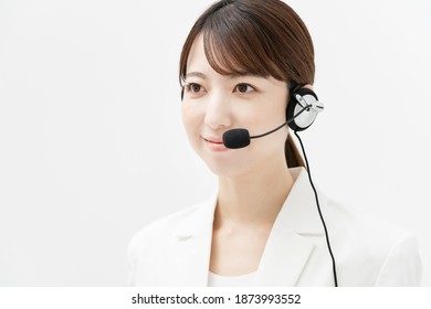 Woman In White Suit Wearing A Headset