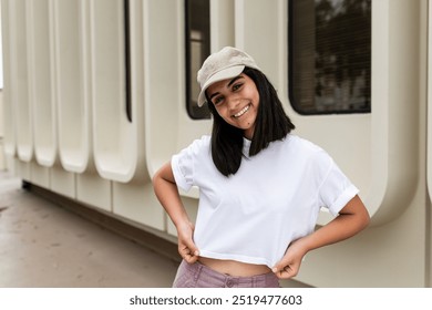 Woman in white tee, wearing beige cap, happy young woman wearing white plain crop top, woman with casual outfit fashion, young woman casual outfit - Powered by Shutterstock