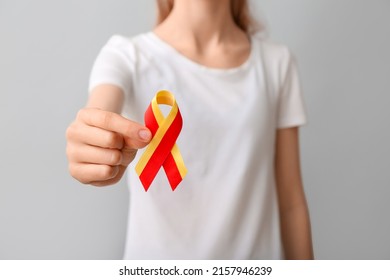 Woman in white t-shirt with awareness ribbon on grey background, closeup. Hepatitis concept - Shutterstock ID 2157946239