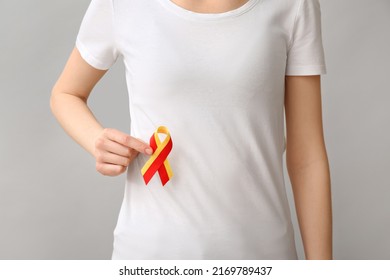 Woman In White T-shirt With Awareness Ribbon On Grey Background. Hepatitis Concept