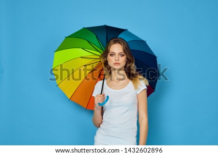 woman in a white T-shirt holds in her hand a beautiful umbrella                               