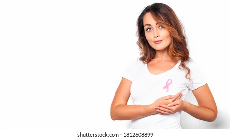 Woman in white t-shirt with pink ribbon supporting breast cancer awareness campaign. Breast Cancer Awareness Month - Shutterstock ID 1812608899