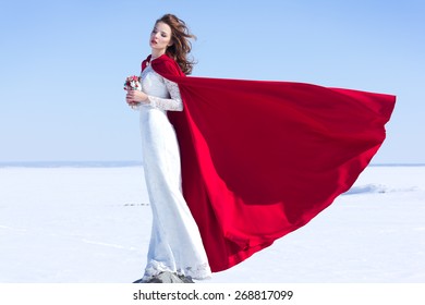 Woman In White Waving Dress With Red Flying Fabric