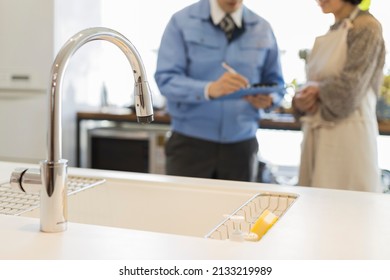 A Woman Who Consults With A Kitchen Remodeling Contractor