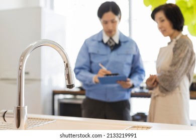 A Woman Who Consults With A Kitchen Remodeling Contractor