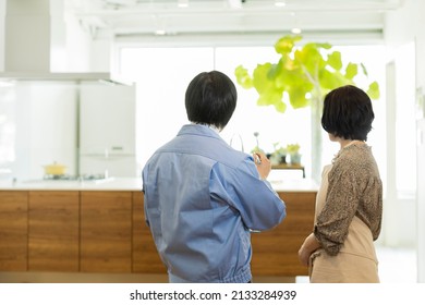 A Woman Who Consults With A Kitchen Remodeling Contractor