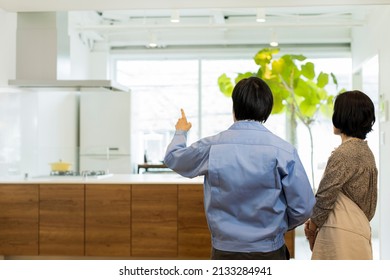 A Woman Who Consults With A Kitchen Remodeling Contractor