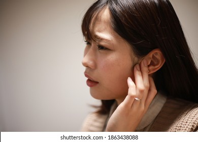 A Woman Who Feels Uncomfortable In Her Ears