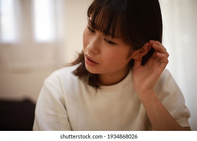 A Woman Who Feels Uncomfortable In Her Ears 