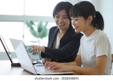 A woman who gives individual guidance on a personal computer  - Shutterstock ID 2028358691