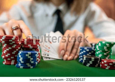 woman who knows how to play poker perfectly sits at a poker table with cards and chips. money game concept. isolated on plain background