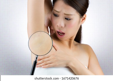 A woman who puts a loupe on her armpit. - Shutterstock ID 1671420676
