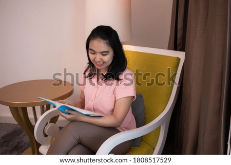 a woman who is reading a book in the room